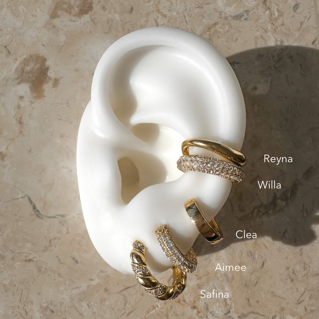 Safina Earrings in Gold by Alexa Kelley. Gold hoop earrings styled in ear stack with hoops, huggies and and cuff earrings.